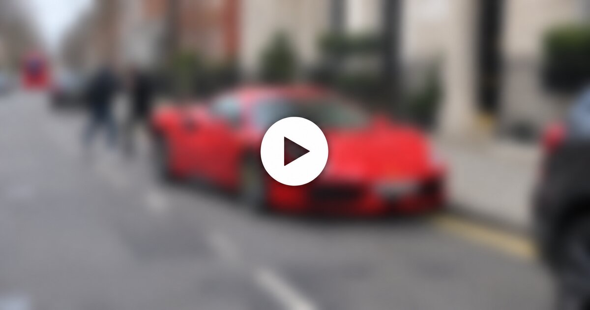 Illustrative image: a red Ferrari in London with a blurred scene and a sharp Play button.